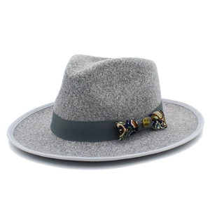 Detailed texture of gray wool fedora hat with paisley pattern bow and metallic button