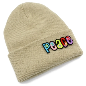 Detailed view of colorful Peace embroidery and floral patterns on a beige knit beanie