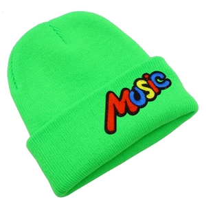 Close-up of vibrant neon green beanie with rainbow colored MUSIC letter embroidery