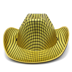 Close-up of golden western cowboy hat with black grid pattern and metallic reflective finish