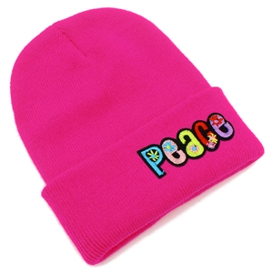 Close-up of colorful PEACE embroidery and floral details on a rose red knitted beanie