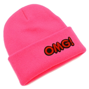 Detailed close-up of bright pink knitted beanie with embroidered OMG text on the cuff