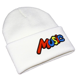 Detailed close-up of colorful MUSIC embroidery on a white ribbed knit beanie hat