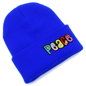 Detail of colorful PEACE embroidery with floral patterns on bright blue knit beanie