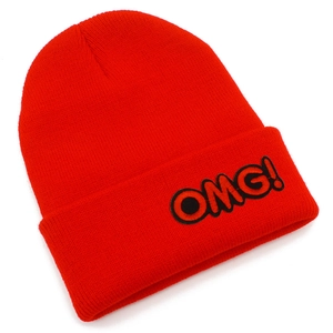 Detailed view of the red knitted beanie featuring the black OMG! embroidered patch