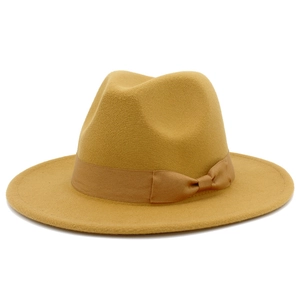 Detailed side view of mustard yellow wool fedora hat with matching ribbon and bow