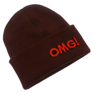 Detailed knit texture of dark brown winter beanie featuring orange OMG! embroidery patch