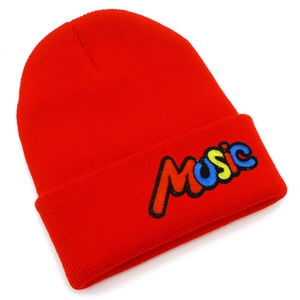 Detailed view of the red knitted beanie with colorful MUSIC embroidery and fine texture