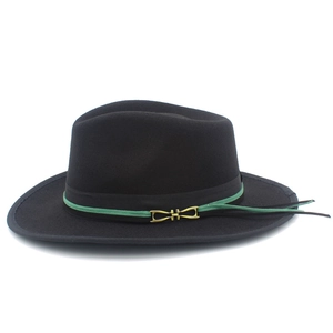 Detailed macro of a black wool felt fedora featuring green trim and golden horsebit buckle
