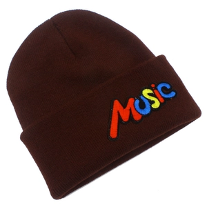 Detailed texture of brown knit beanie featuring colorful 3D MUSIC embroidery design