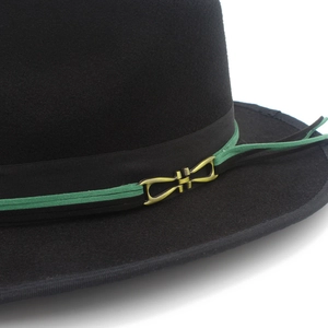 Detail of wool fedora hat with green ribbon band and vintage bronze metal buckle