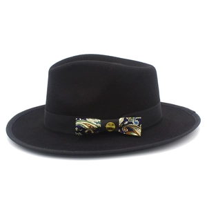 Detail of wool fedora hat with paisley pattern bow and vintage metallic buckle