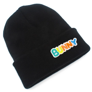 Detail of black knitted beanie featuring colorful BUNNY letter embroidery patch