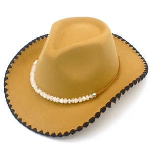 Detail of khaki felt cowboy hat featuring black stitched brim and white bead chain