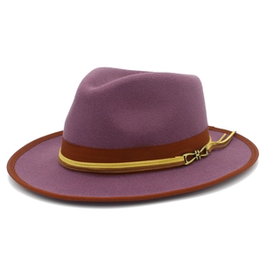 Detail of purple wool fedora hat featuring brown grosgrain band and tassel accent