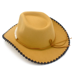 Detail of yellow felt cowboy hat featuring bead accents and black contrast stitching