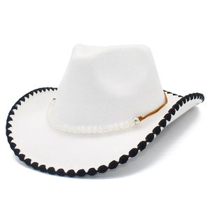 Detail of white felt cowboy hat with black wavy lace edge and beaded decorative band
