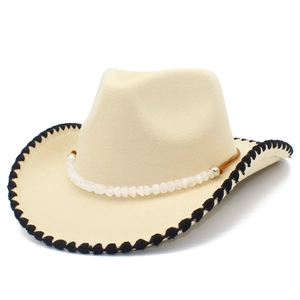 Detail of western felt cowboy hat with beaded chain and black braided brim edge