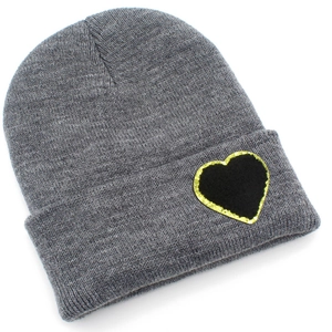 Detail view of grey ribbed knit beanie featuring a black and gold glitter heart patch