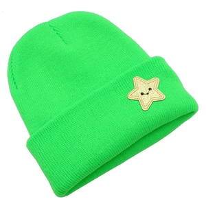 Detailed macro view of neon green ribbed knit beanie with yellow star embroidery patch