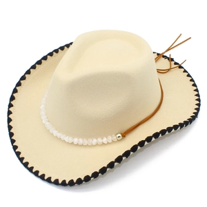 Detail of cream western cowboy hat with black serrated trim and beaded leather band