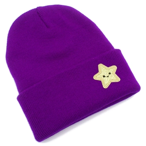 Detail of purple knitted beanie featuring a yellow star patch with a smiley face design