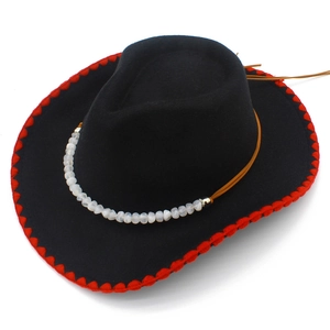 Detail of western black felt cowboy hat with red stitched edge and beaded trim band
