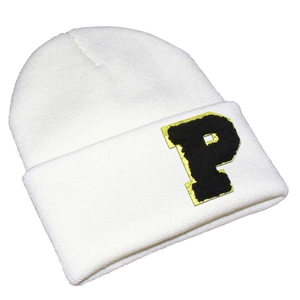 Detail of white knit beanie showing black chenille letter P patch with gold embroidery trim