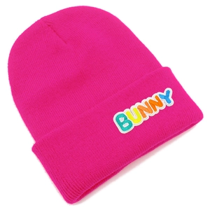 Close-up of vibrant rose pink beanie with colorful Bunny letter patches and knit texture