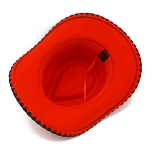 Detail of red cowboy hat interior showing the fabric care label and decorative trim