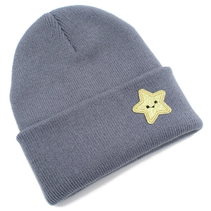 Close-up of a dark grey knitted beanie featuring a bright yellow star smile embroidery