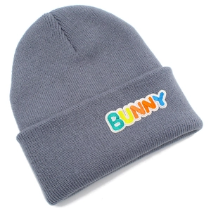 Close-up of grey ribbed knit beanie featuring colorful embroidered Bunny letters