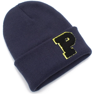 Detailed close-up of navy blue knit beanie featuring a premium gold-edged letter P patch