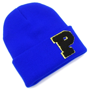 Detail of royal blue knit beanie with a black letter P patch and gold glitter border