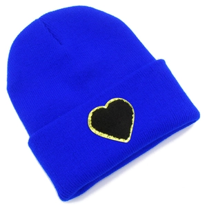 Blue knit beanie with gold-trimmed heart patch in a minimalist ribbed style