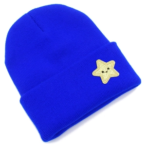 Detail of bright blue knitted beanie with yellow star smiley face embroidery patch