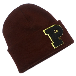 Detailed close-up of burgundy knit beanie featuring a vintage P letter patch on the cuff