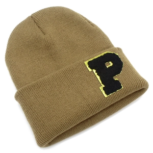 Detail of khaki ribbed knit beanie featuring a fuzzy black letter P patch with gold trim