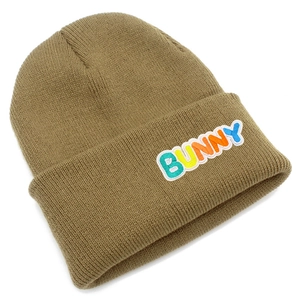 Detailed knit texture of a khaki beanie featuring colorful embroidered BUNNY lettering