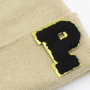 Knitted beanie hat with embroidered P letter patch and shiny golden sequin edges