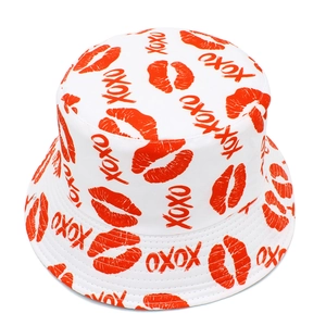 Top view of bucket hat with all-over red lip prints and XOXO pattern on white fabric