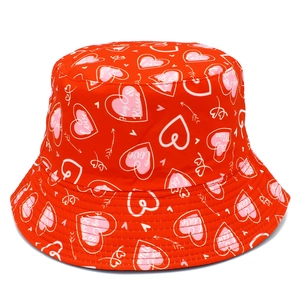 Close-up of red bucket hat with white hearts and Love, Be Mine, Hug & Kisses slogans