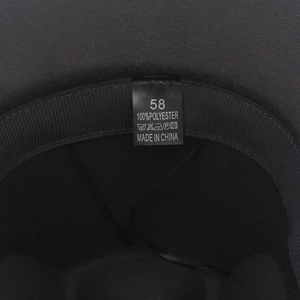 Detail view of the fedora hat's inner sweatband and 100% polyester material label