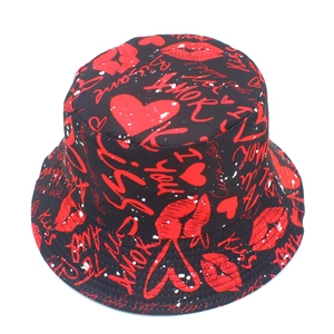 Detail of trendy fisherman bucket hat featuring red heart and love letter graffiti patterns