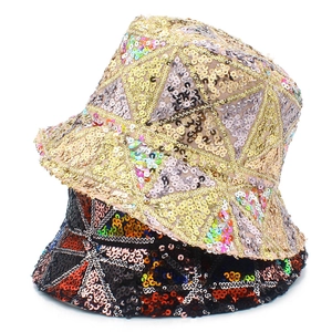 Detailed view of sequin bucket hat with geometric patterns in champagne and black colors
