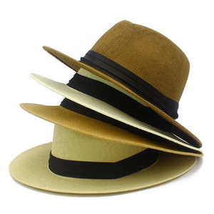 Stack of woven Panama straw hats with black ribbon bands in various neutral colors