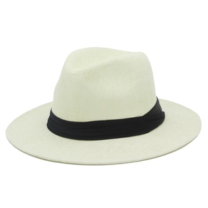 Close-up of cream Panama hat with fine straw weave texture and black ribbon detail