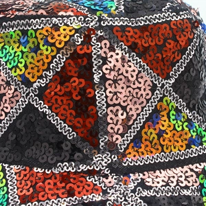 Macro detail of multi-colored sequins on the punk style bucket hat with geometric patterns