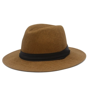 Detailed view of the fine woven texture and black ribbon band on a brown Panama fedora hat