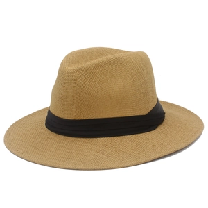 Close-up of fine woven texture on natural straw Panama hat with black ribbon band